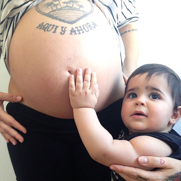 Беременная татуированная женщина и ее сын.